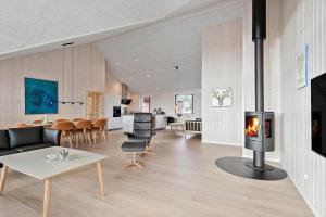 a living room with a fireplace in the middle at 0257-Romo-Chresten-Krommes-Vej-9 in Tagholm