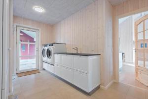 a laundry room with a washing machine and a sink at 0257-Romo-Chresten-Krommes-Vej-9 in Tagholm +17 photos