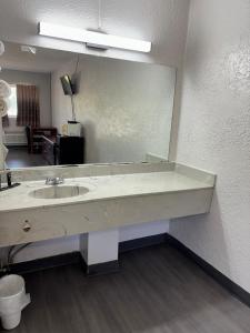 a bathroom with a sink and a large mirror at Anchor inn in New Johnsonville +2 photos