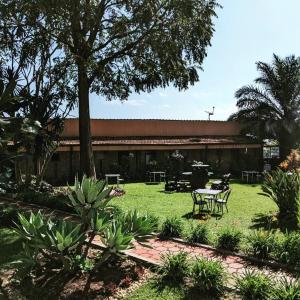 a building with a table and chairs in a yard at Inside Afrika Boutique Hotel in Kigali