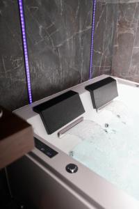a machine with two monitors on top of it at LoveRoom La Petite Suite avec SPA in Brest +43 photos