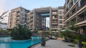 un grand bâtiment avec une piscine devant dans l'établissement The Diamond in City luxury suites by Cozy, à Accra