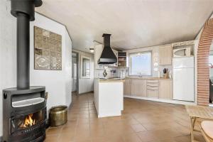 a kitchen with a stove in the middle of a room at 0073-Romo-Lakolk-172 in Lakolk