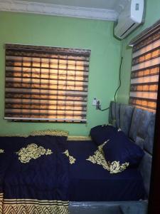 a bedroom with a bed with blue sheets and a window at Mandy's Closet in Olute