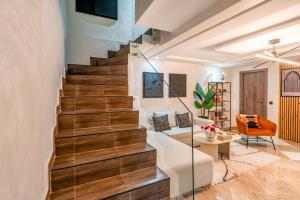 a staircase in a living room with a couch and a chair at Marrakech Duplex Spacieux avec Terrasse in Marrakech