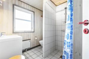 a bathroom with a toilet and a sink and a window at 0074-Romo-Lakolk-174 in Lakolk +17 photos