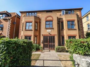 a brick building with a gate in front of it at Flat 9 in Swanage