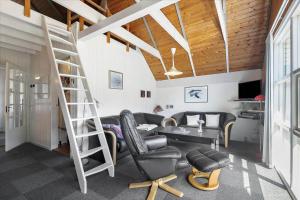 a living room with a ladder and a table and chairs at 0273-Romo-Lyngvejen-63-B in Rømø Kirkeby
