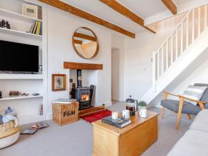 a living room with a fireplace and a tv at 3 Bed in Polruan PC009 in Fowey