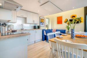 a kitchen and living room with a table and chairs at Wash House - Tayport in Dundee