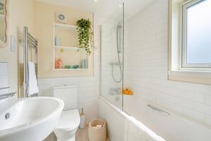 a bathroom with a tub and a toilet and a sink at Wash House - Tayport in Dundee +19 photos