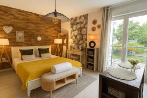 a bedroom with a large yellow bed and a window at Petit cocon cosy proche place Stanislas-Parking & cave vélos in Nancy