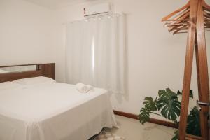 Ένα ή περισσότερα κρεβάτια σε δωμάτιο στο Apartamento Novo ao lado da Rua Mucugê com Ar, Wi-Fi, Estacionamento +24 φωτογραφίες