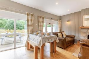 a living room with a table and a couch at 2 Bed in Newtonmore oc-d32413 in Newtonmore