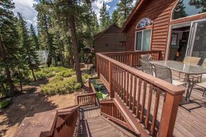 a wooden deck with a table on a house at Tahoe Haven By Hauserman Rentals in Carnelian Bay