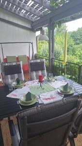 a table with plates and napkins on a patio at Haus WoogArt in Dahn
