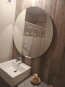 a bathroom with a white sink and a mirror at Monoambiente Zuly in San Miguel de Tucumán