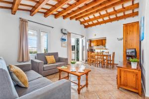 una sala de estar con un sofá y una mesa en Villa Airosa by Villa Plus, en Cala'n Porter