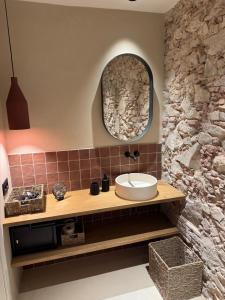 a bathroom with a sink and a stone wall at BELLADORA Hotel Boutique in Lloret de Mar +64 photos