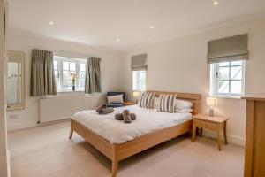 a bedroom with a bed with two towels on it at Pembroke Cottage in Walberswick