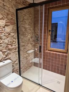 a glass shower in a bathroom with a toilet at BELLADORA Hotel Boutique in Lloret de Mar