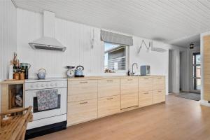 a kitchen with wooden cabinets and a stove at 0035-Romo-Lakolk-39 in Lakolk