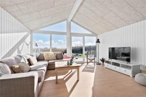 a living room with a couch and a tv at 0035-Romo-Lakolk-39 in Lakolk