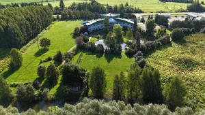 an aerial view of a house with trees and a river at Viesnīca Garden in Tīnūži
