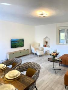 a living room with a table and chairs at Stone house Kana-Skadar Lake in Dodoši