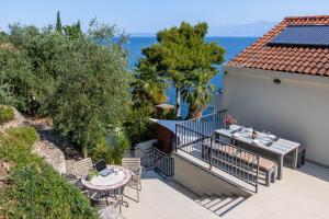 a balcony with a table and chairs and the ocean at Apartments Maestral in Trpanj
