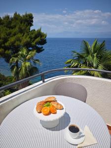 a table with a plate of food and a cup of coffee at Apartments Maestral in Trpanj