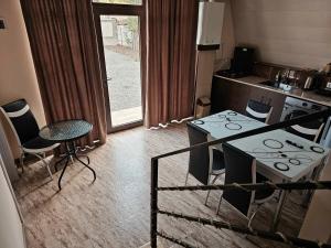 a kitchen with a stove and a table and chairs at Borjomi Summit in Borjomi