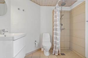 a bathroom with a toilet and a sink at 2601-Romo-Praestekraven-7 in Mølby +26 photos