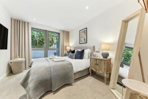 a bedroom with a bed and a large window at Springfield Two in Harrogate