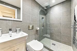 a bathroom with a shower and a toilet and a sink at Springfield Two in Harrogate +29 photos