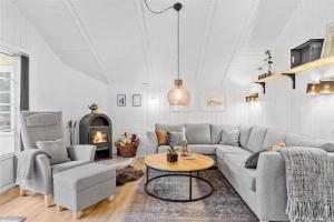 a living room with a couch and a table and a fireplace at 0155-Romo-Davidstraede-10-c in Kongsmark