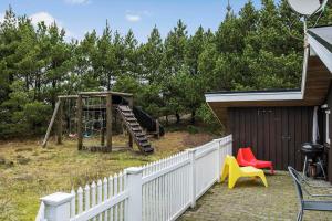 a playground with a slide in a yard at 0011-Romo-Trinnesvej-9 in Bolilmark