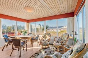 a living room with chairs and a table and windows at 0053-Romo-Lakolk-19 in Lakolk +14 photos