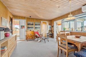 a kitchen and dining room with a table and chairs at 0053-Romo-Lakolk-19 in Lakolk
