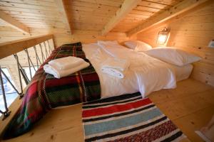a bed in a wooden room in a cabin at Montis House in Vişeu de Mijloc