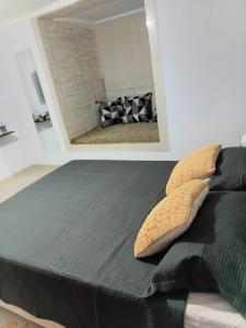 a bedroom with a black bed with a mirror at Rota dos Vinhedos in Espirito Santo Do Pinhal