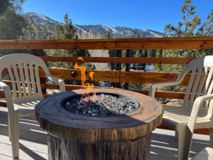 a fire pit sitting on a deck with two chairs at Yosemite Pines Cabin - Sleeps 6 in Big Bear Lake