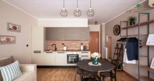 a kitchen and a living room with a table and chairs at Eur Crystal Garden - Loft moderno con Terrazza privata e Box auto in Rome