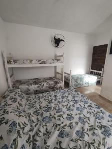 a bedroom with a bed with a blue and white comforter at Novo Encanto in Ubatuba