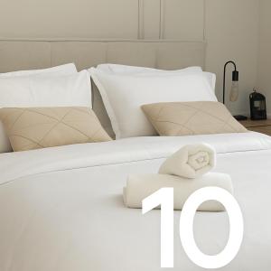 a white bed with a number on it at Emanuel Suite in Eilat