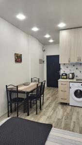 a kitchen with a table and chairs in a room at Ande Tower, Batumi in Minda