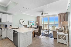 a kitchen and living room with a view of the ocean at Waters Edge 415 - Breathtaking Beach Front Views - Free Beach Svc in Fort Walton Beach