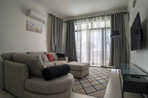 a living room with a couch and a chair at The Nest at Baobab Waves in Mombasa