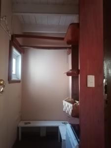 a small room with a table and a window at Habitación Refugio en la Isla in Isla Negra