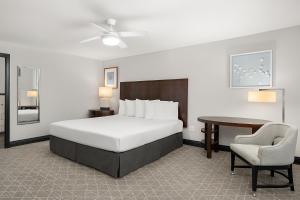 a bedroom with a bed and a desk and a chair at Tilden Hotel in San Francisco +46 photos